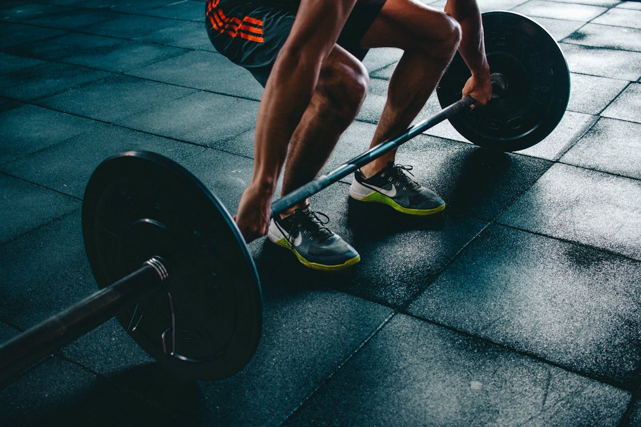 Offering Man performing a deadlift exercise in a gym, demonstrating strength and fitness.